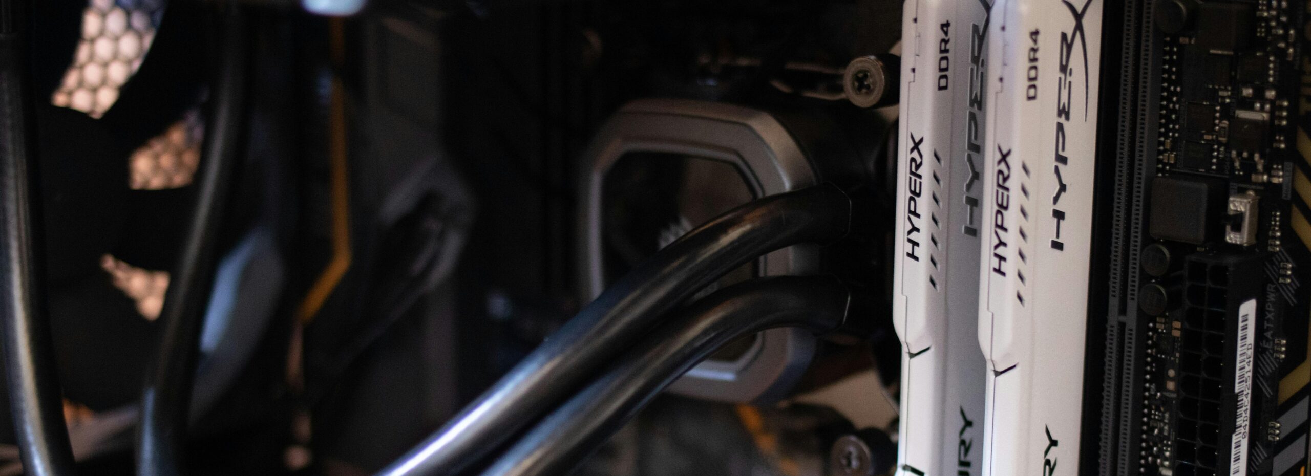Detailed close-up of computer components including RAM and cables inside a server or high-performance PC.